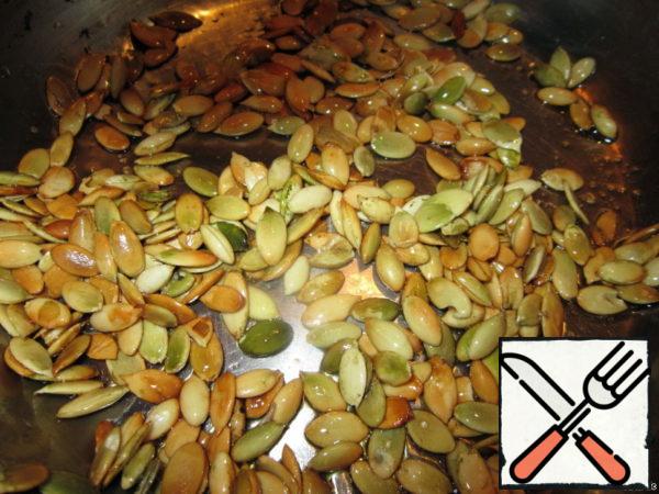 Heat the olive oil in a frying pan and fry the seeds until golden brown.
