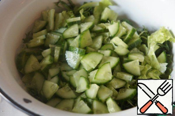 Slice the cucumber and add it to the salad.
