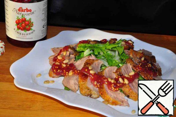 Sprinkle pine nuts on top of the salad.