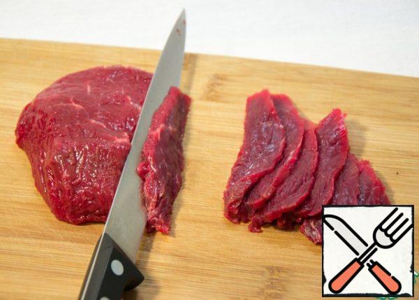 Cut beef with a sharp fillet knife into translucent slices.
