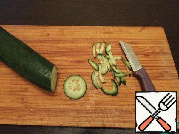 Cut cucumbers into strips.
