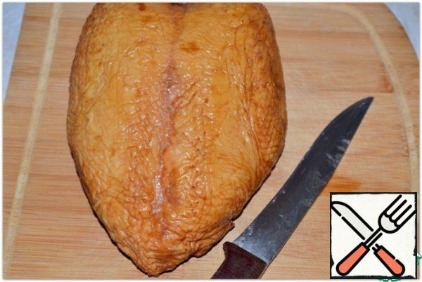 Peel the smoked chicken breast from the skin and bones.
