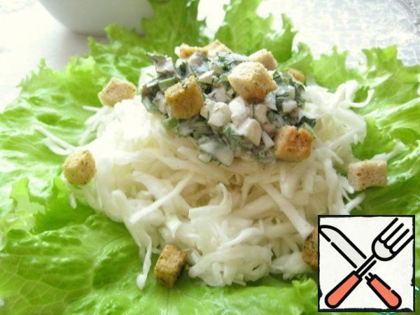 Serve the salad in portions. Put the lettuce leaves on a plate, slide the cabbage, pour the dressing and sprinkle with croutons.