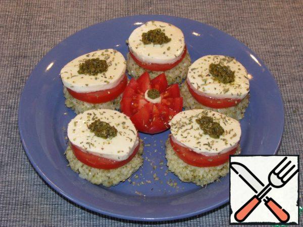 Spread on rice balls tomato circle, a circle of mozzarella, a little pesto sauce on top. You can sprinkle all dried mixture of Italian herbs or decorate with Basil leaves.
