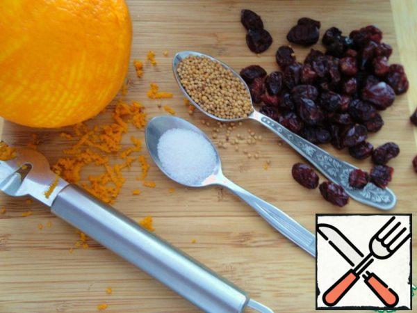 Remove the zest from the orange and squeeze the juice. In a Cup, mix cabbage, zest, mustard seeds, 0.5 tsp .salt and a little RUB with your hands to make the cabbage a little softer. Add cranberries.