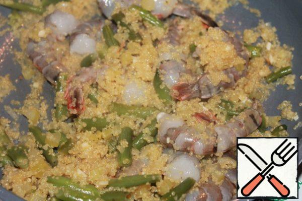 Peel the shrimp and add to our dish, simmer for another 5 minutes.
