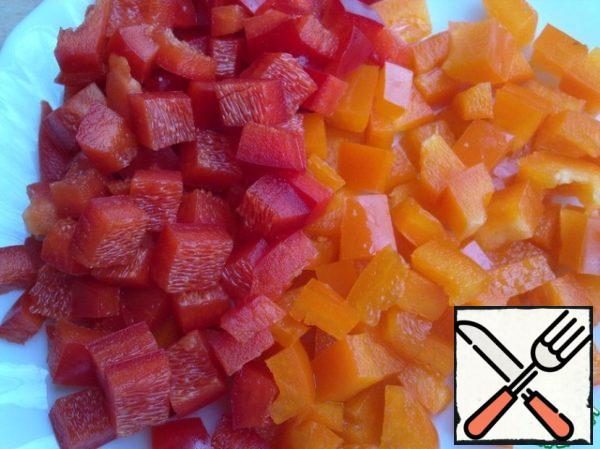 Bulgarian pepper red and orange cut into pieces.