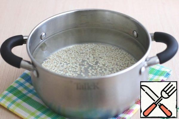 Pour cold water (2.5 liters) into a saucepan, pour the washed pearl barley. Put the pan on medium heat, let it boil, if necessary, remove the resulting foam. Next, reduce the heat to a minimum and cook the porridge until half cooked.
