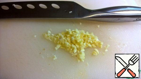 Finely chop the garlic and add it to the onion.
