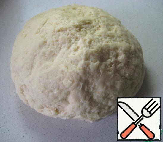The dough is soft, smooth, not sticking to the hands. Knead it well. Grease the dough bun with vegetable oil, cover the bowl with the dough with a napkin and leave to rise in a warm place for 2 hours.
