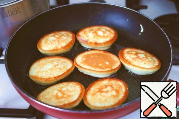 Add vegetable oil (1/4 cup) to the pan. Spoon each portion of dough onto a baking sheet. Bake the pancakes until lightly browned on both sides.
