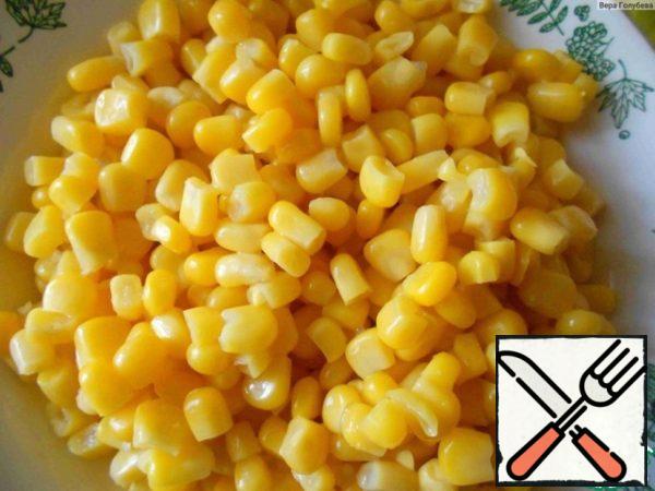 I start cooking by taking the corn out of the jar.
