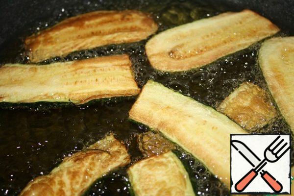 Fry the zucchini until golden brown.
