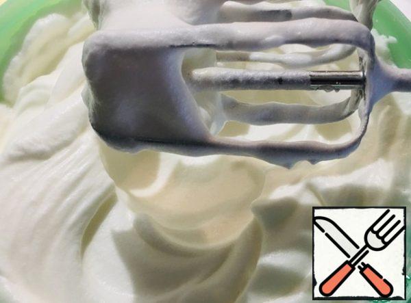 In a separate bowl, whisk the egg whites to steady peaks.
