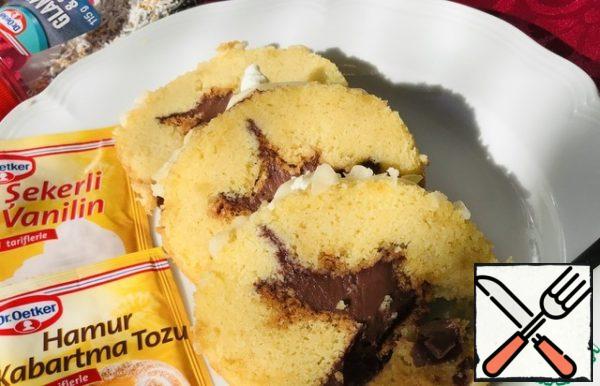 Carefully unwrap, spread the biscuit, roll up, also twist the edges of the paper, leave to cool.
The finished result.
Decorate with pastry sprinkles.
