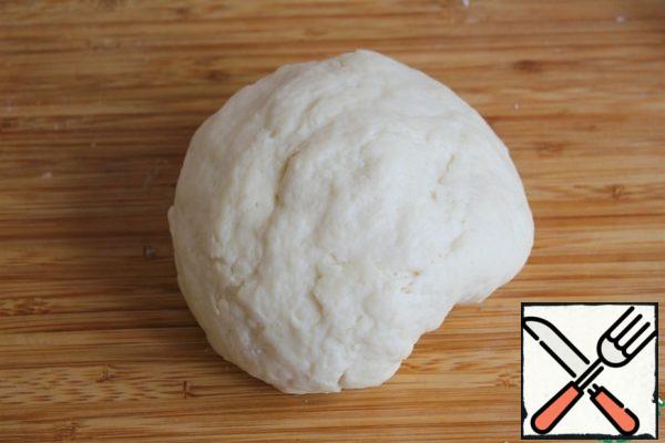 Add the sifted flour with baking powder and knead the soft dough.
Depending on the curd, you may need more or less flour, so add the flour in parts.