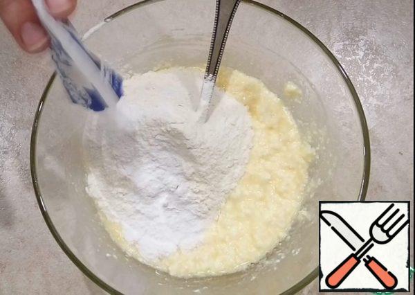 Add the sifted flour and baking powder. Mix everything thoroughly.

