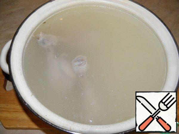 Cook the chicken broth (then I separate the chicken meat from the bones and return it to the soup).
