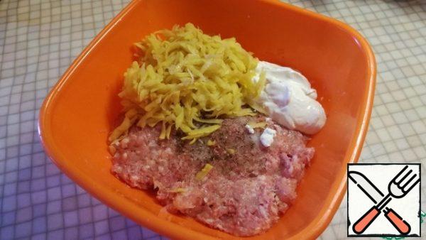 In a deep bowl spread the minced meat, add sour cream two tablespoons, grated potatoes. Salt and pepper to taste. Stir Well.