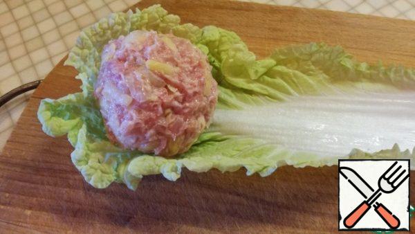 Wash the leaves of the cabbage. On every leaf put an our meatballs and turn.