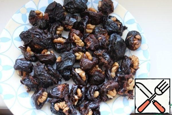If the prunes are hard, then soak them in water.
Stuff with walnuts, spread on hot bread.

