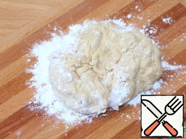 Then put the dough on a cutting board and add 1 tablespoon of the remaining flour (20 g).
