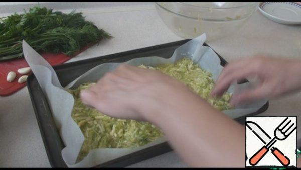 Add grated cheese, eggs, salt, pepper to taste to the zucchini, mix well. Cover the 25 by 30 cm form with parchment paper and lubricate it well with sunflower oil. Place the zucchini dough on a baking sheet and bake in a preheated 230 degree oven for 35 minutes.
