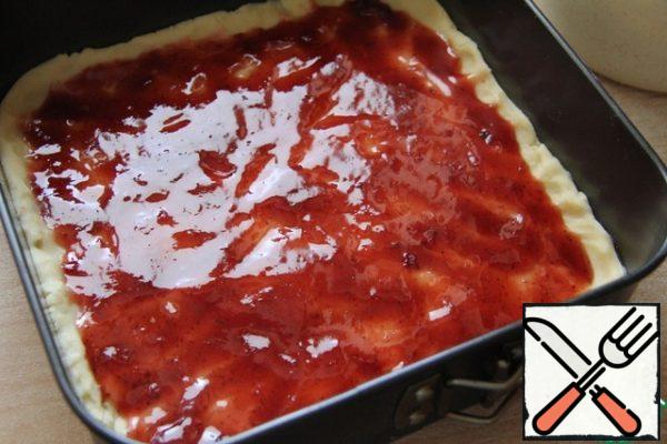 Put it in a shortbread mold. Spread it with jam.

