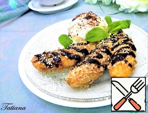 Hot bananas rolled in coconut flakes. Put the bananas on a plate, add a ball of ice cream, pour the chocolate syrup.