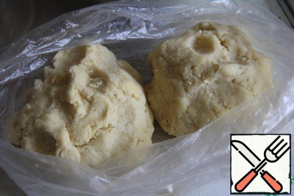 Knead the plastic dough. Divide in half, wrap in a bag and refrigerate for at least 30-60 minutes. Or put some of it in the freezer.
