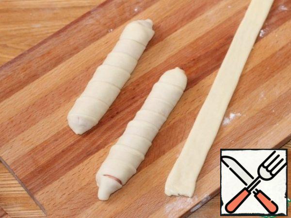 We form cutlets - hearts. Roll out each part of the dough (6 pcs.) into a long flat cake, cut into 3 parts, lubricate with melted butter.
