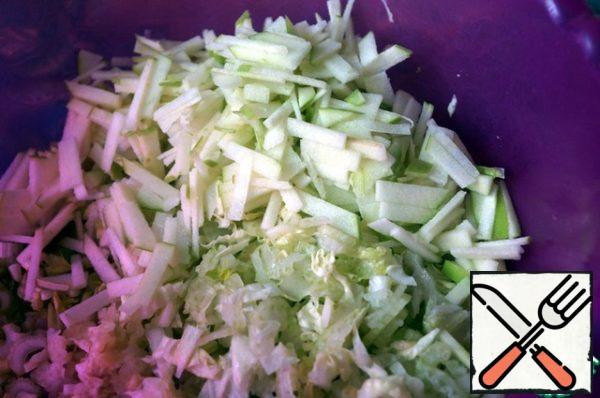 Slice the apple as thinly as possible, combine with cabbage and celery.
