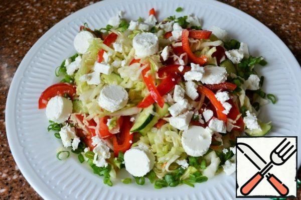 Put the vegetable mixture on a serving dish, and pieces of cheese on the vegetables.

