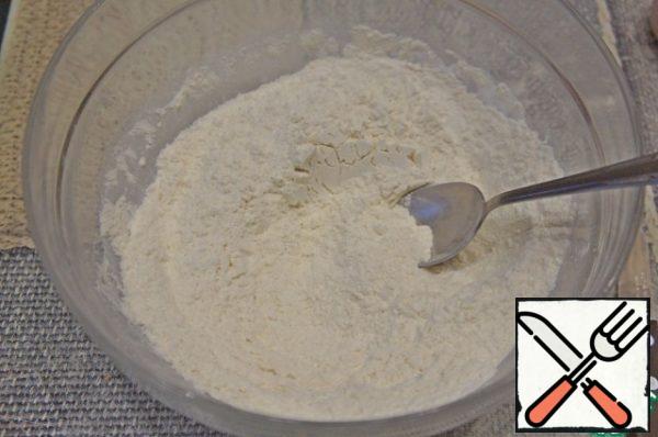 Sift flour into a separate bowl, add baking powder and mix.