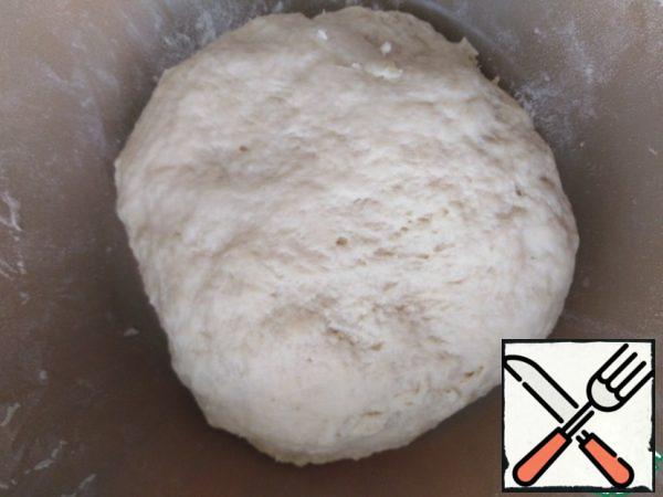 Sift flour and mix with yeast. Pour the kefir mixture gradually and knead the dough. Cover and put in heat for 30 minutes.
