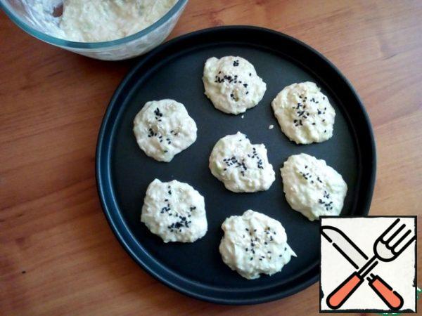 Spread on non-stick form or baking paper with a spoon. Sprinkle with sesame seeds on top. You can do with a poppy.
