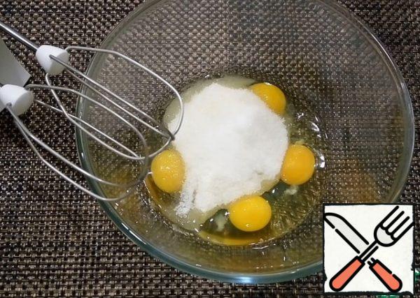 In a bowl, beat eggs, sugar, and vanilla sugar into a froth.