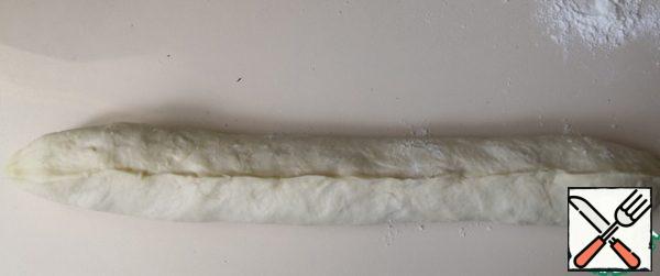The first "strand" braids ready. Remove it to the side and cover so that the dough does not air.