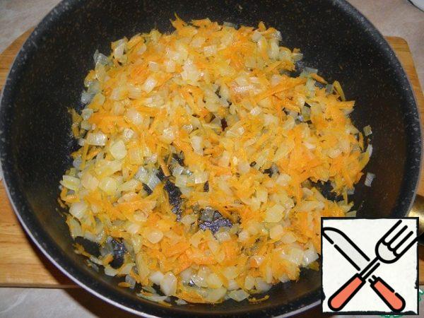 Fry onions and carrots until soft