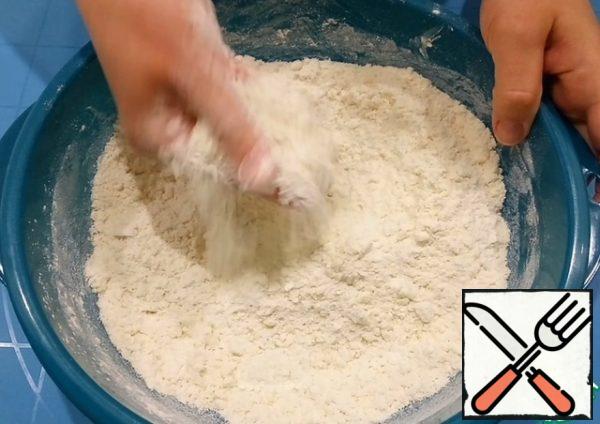 Add butter at room temperature and mix with your hands until crumbs form.