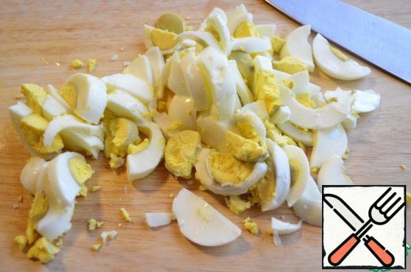 Boil the eggs and chop them.
