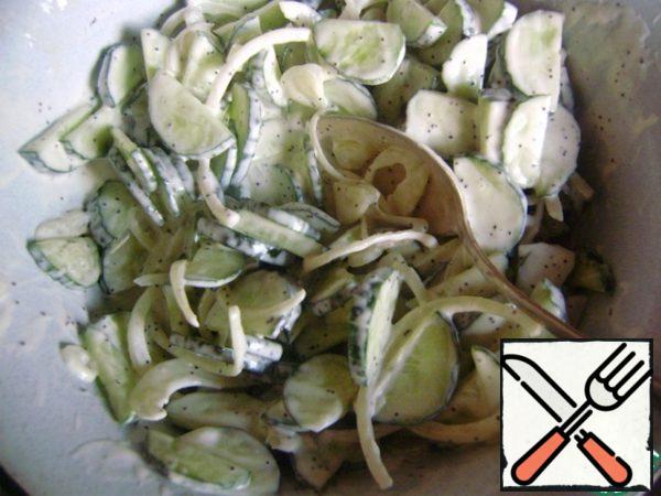 Pour the dressing over the cucumbers and onions.
