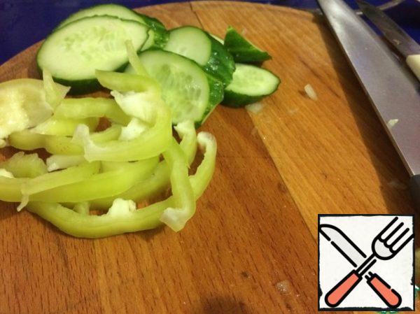 Cut cucumbers, peppers, cherries into halves.
