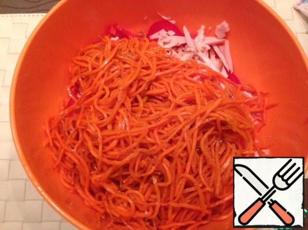 Put the chopped pepper and chicken in a deep container. Add the carrots in Korean.
