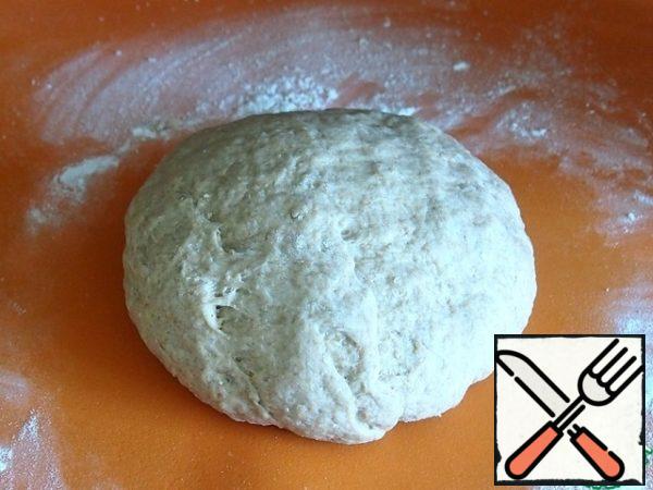 Knead the dough on the table, you may have to add a little flour, but only a little. Do not "hammer" the dough with extra flour, it should turn out soft and elastic.
