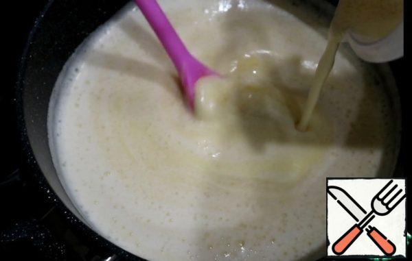 In the heated milk pour a thin stream of egg mixture, stirring constantly. Cook over medium heat.