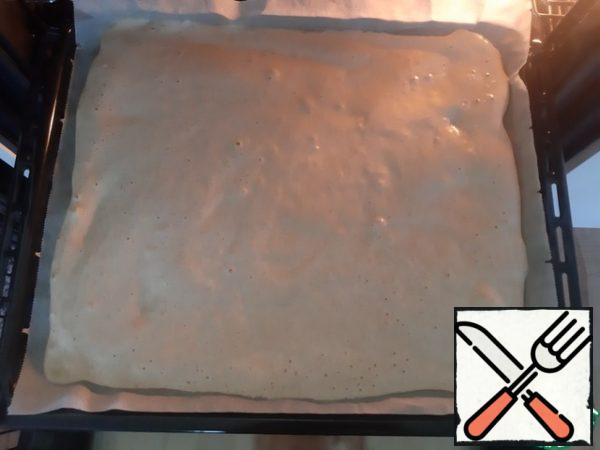 Cover the baking sheet with baking paper. Put the dough on a baking sheet, smooth it with a spatula.
Bake for 10 minutes.
Take out the roll and lay it upside down (there will be baking paper on top) on a towel. Take another wet towel to wipe the top of the roll with it, on which we have baking paper laid. (This is necessary so that the baking paper easily separates from the roll and does not damage the soft cake)
Then very quickly spread the roll with your favorite jam and roll it into a roll.
At this stage, the photo is not taken, because you need to work very quickly. I hope an explanation is available.
That's all you can enjoy.
