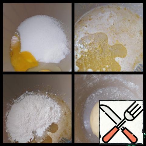 Combine sugar, vanilla, salt, egg +yolk and mix thoroughly. Add oil and lemon zest, stir, then add flour with baking powder and knead the soft dough. You may need less flour, the main thing to achieve the desired consistency.
