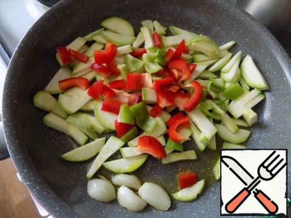 Fry the zucchini for a couple of minutes, add finely chopped pepper. I use both red and green colors. Fry for another minute.

