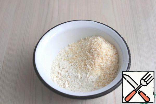 In a separate bowl add flour (2.5 cups), add 4 tablespoons of coconut.